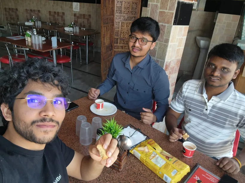A selfie of the team over chai and rusks at a roadside restaurant