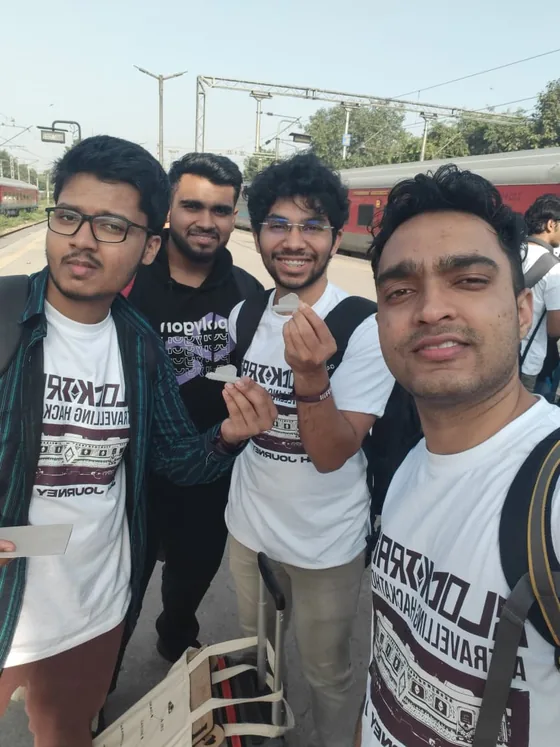 A selfie of four hackers in Blocktrain T-shirts on the platform after arriving in New Delhi
