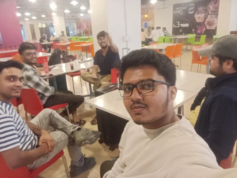 A selfie of Mirza with other hackers at a food court stop