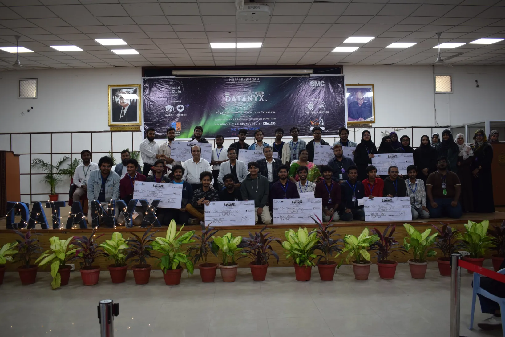 All the Datanyx 2024 winners with their cheques and the organisers, in front of the Datanyx banner