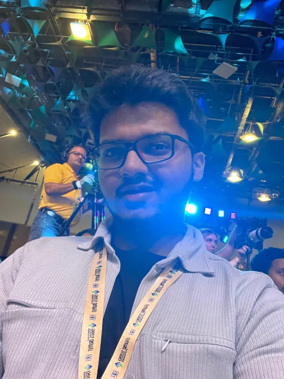 A selfie of Mirza in the crowd, with a camera operator behind him