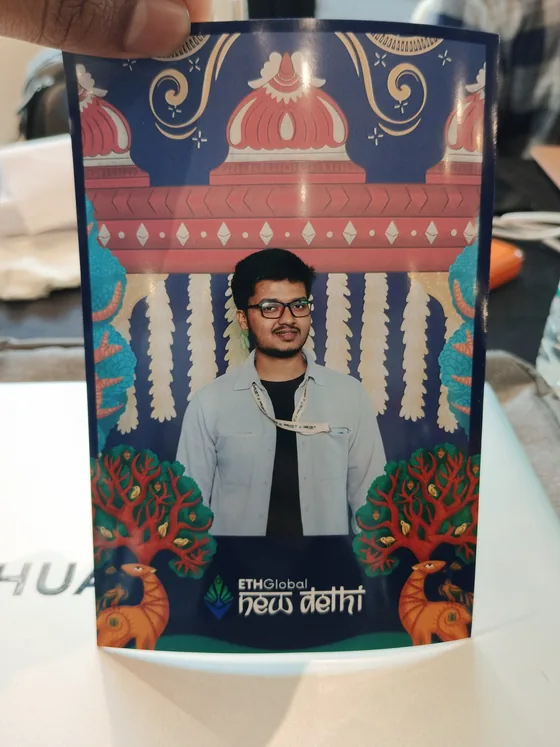A printed photo-booth picture of Mirza in an ETHGlobal New Delhi frame