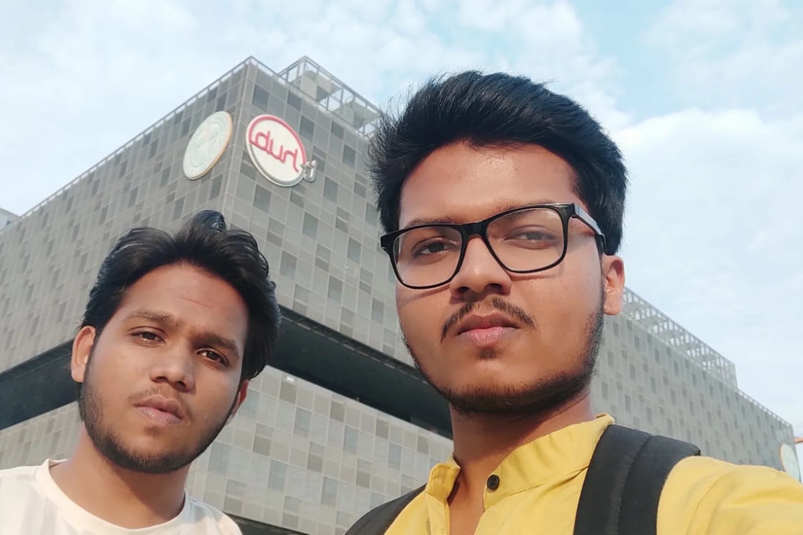 A selfie of Mirza and a friend in front of the T-Hub building