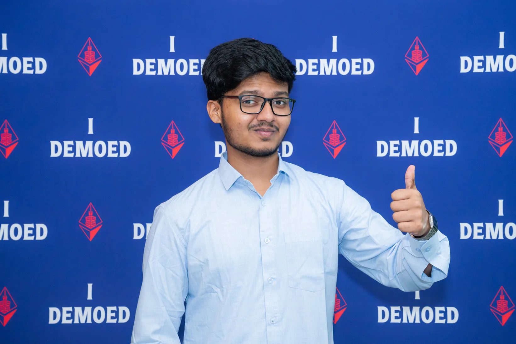 Mirza giving a thumbs up after winning the Polygon track, in front of a blue wall that repeats “I demoed” and the ETHGlobal Taipei logo