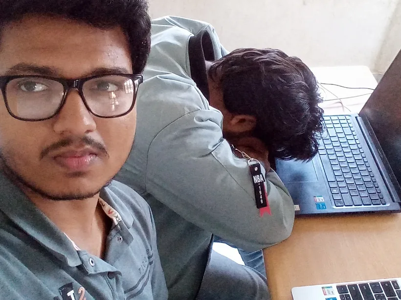 A selfie of Mirza while his teammate sleeps on a laptop