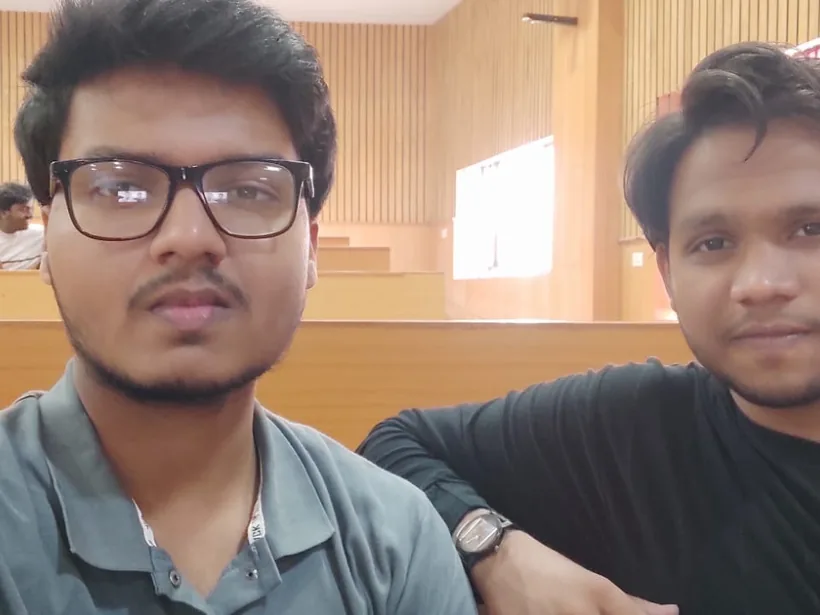 A selfie of Mirza with a teammate in an empty lecture hall